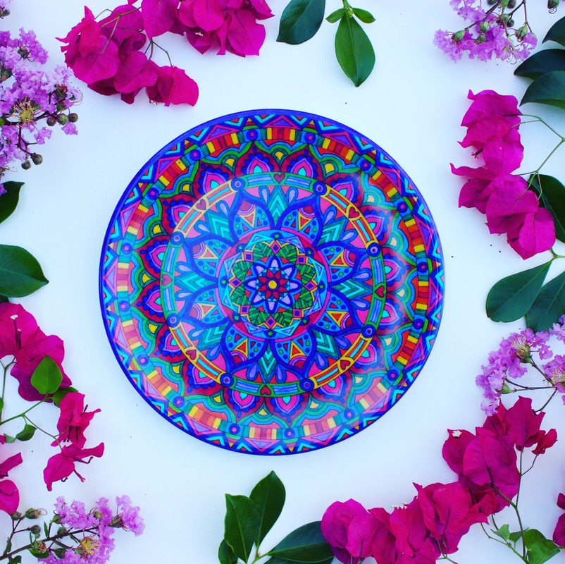 Beautifully hand painted dinnerware surrounded by colourful flowers