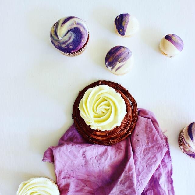 Decorative textiles styled with purple linen napkins and cupcakes